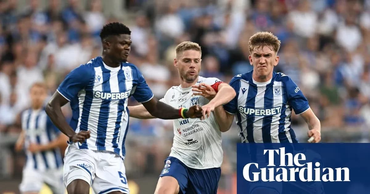Players competing for possession during a football match Players competing for possession during a football match
