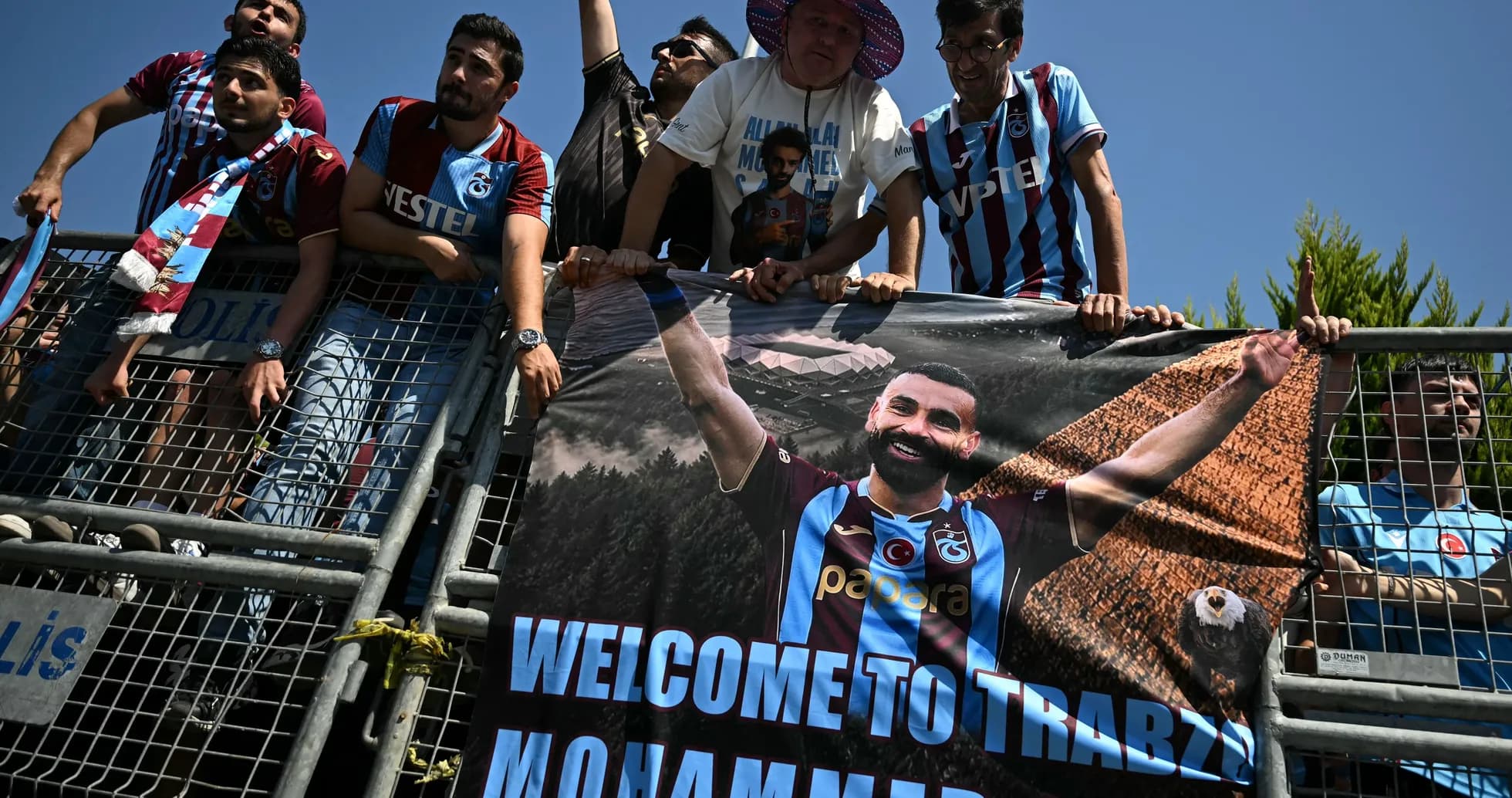 Fans holding banner welcoming player Mohammed Salah Fans holding banner welcoming player Mohammed Salah