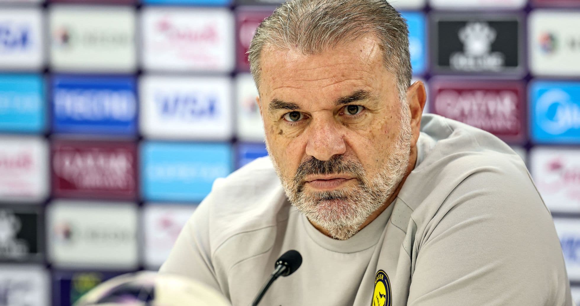 Manager at press conference with microphone and ball Manager at press conference with microphone and ball