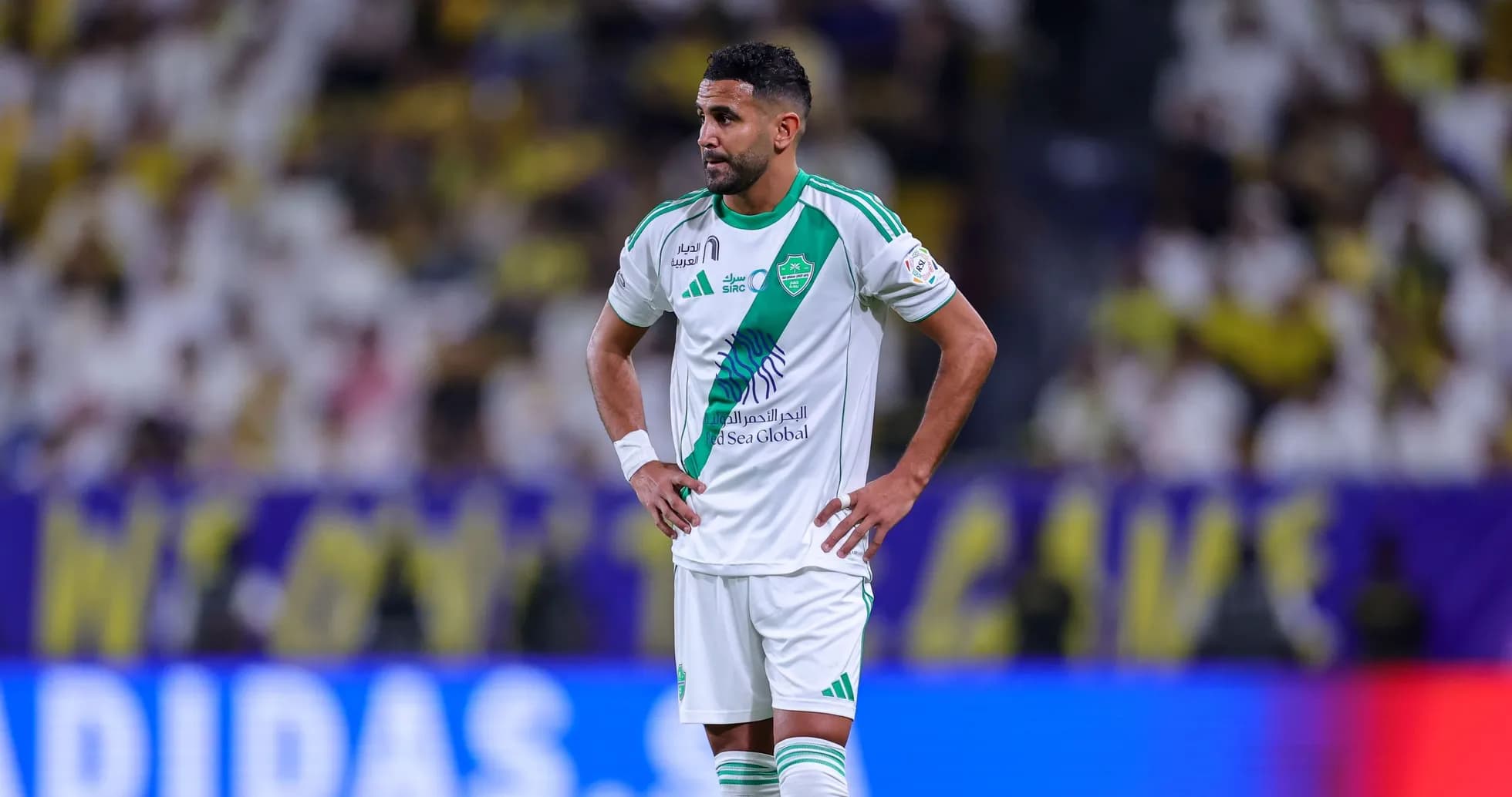 Player in green and white kit on the field Player in green and white kit on the field