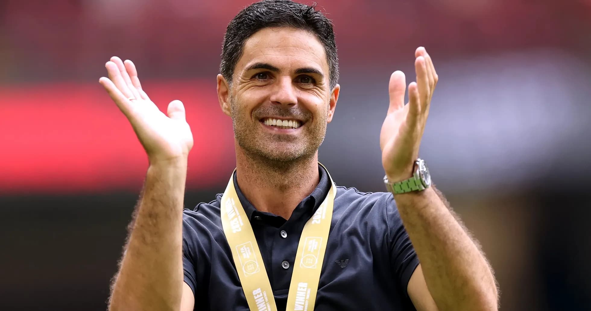 Manager celebrating with hands raised and medal Manager celebrating with hands raised and medal