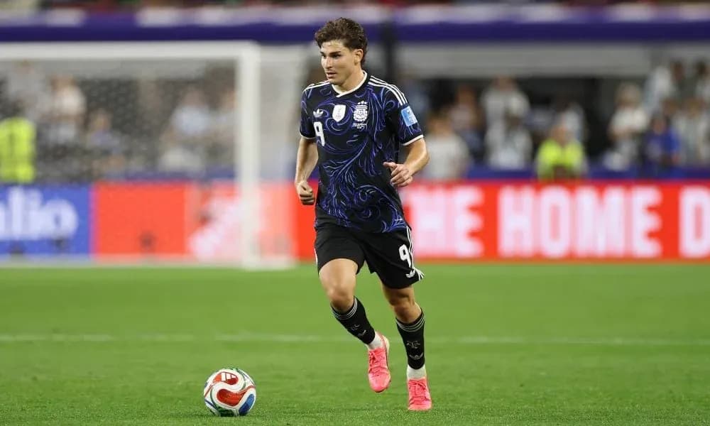 Player in black jersey running on football pitch Player in black jersey running on football pitch