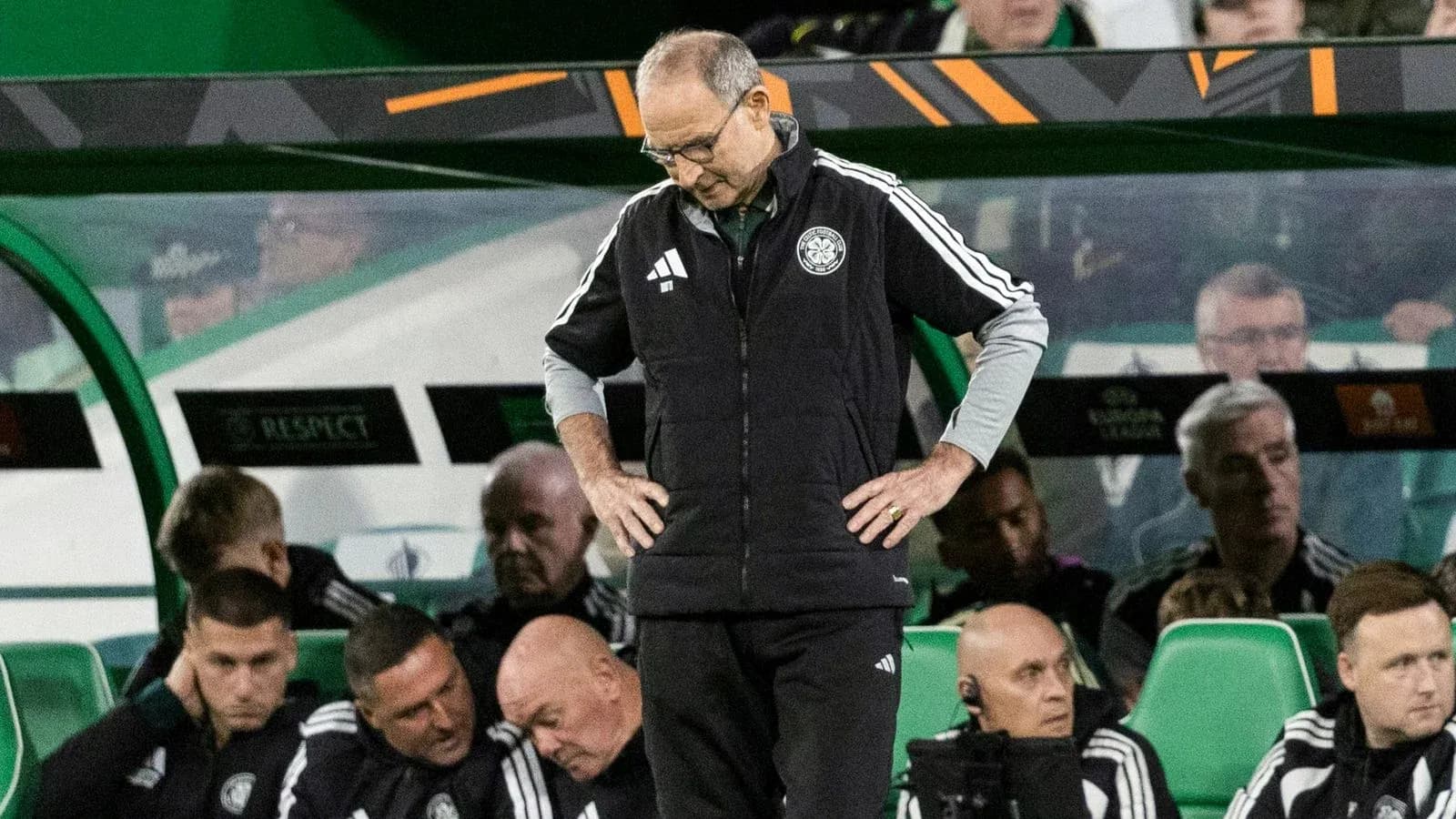 Coach looking down during match on the sidelines Coach looking down during match on the sidelines