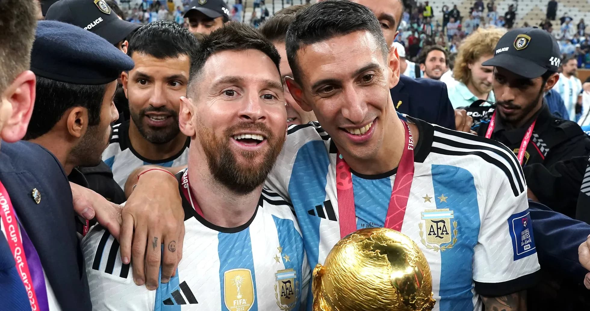 Messi and Di María celebrating with World Cup trophy Messi and Di María celebrating with World Cup trophy