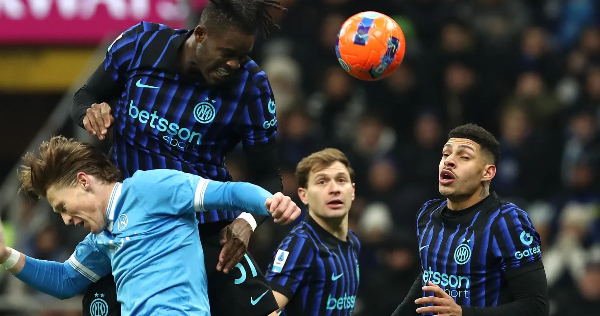 Player heading the ball during intense match action Player heading the ball during intense match action