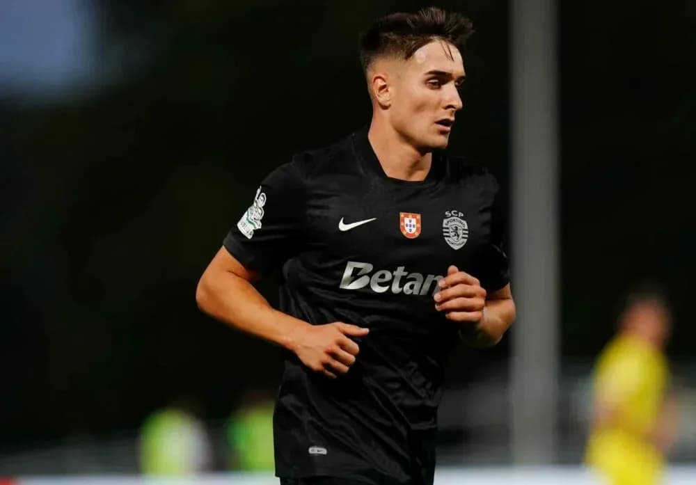 Player running during a football match in black kit Player running during a football match in black kit