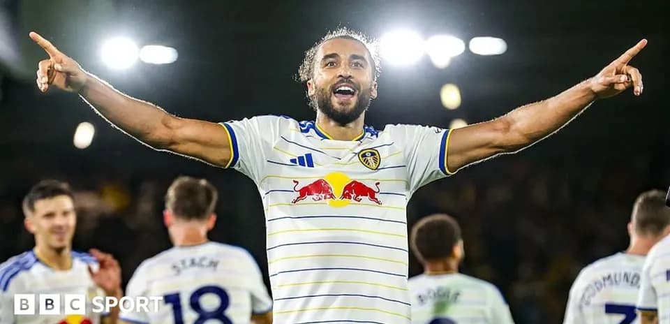Player celebrating a goal with teammates in stadium Player celebrating a goal with teammates in stadium