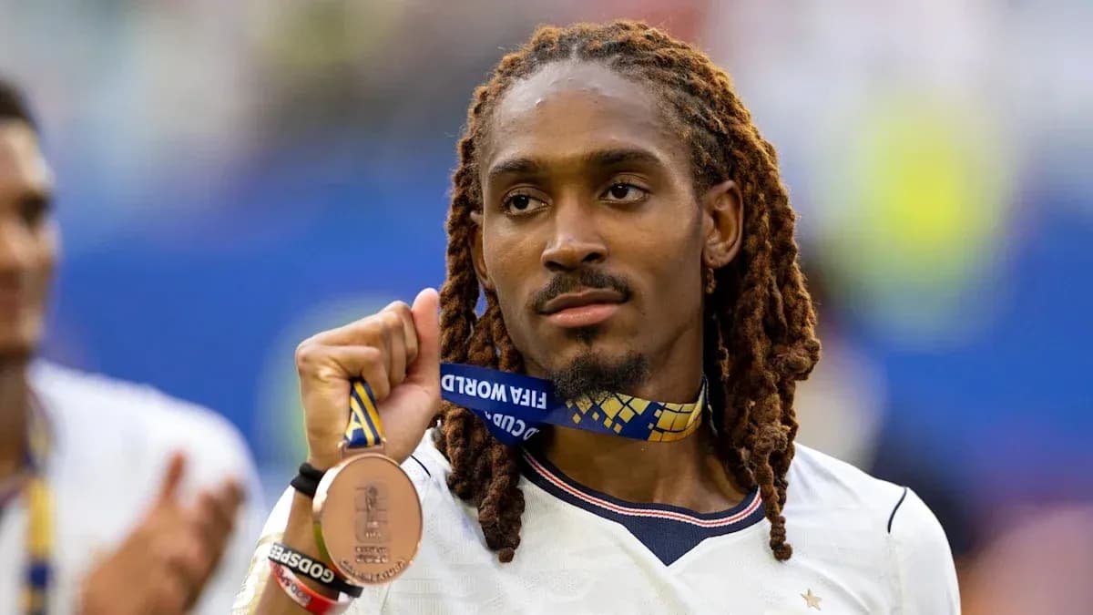 Player holding FIFA World Cup bronze medal proudly Player holding FIFA World Cup bronze medal proudly