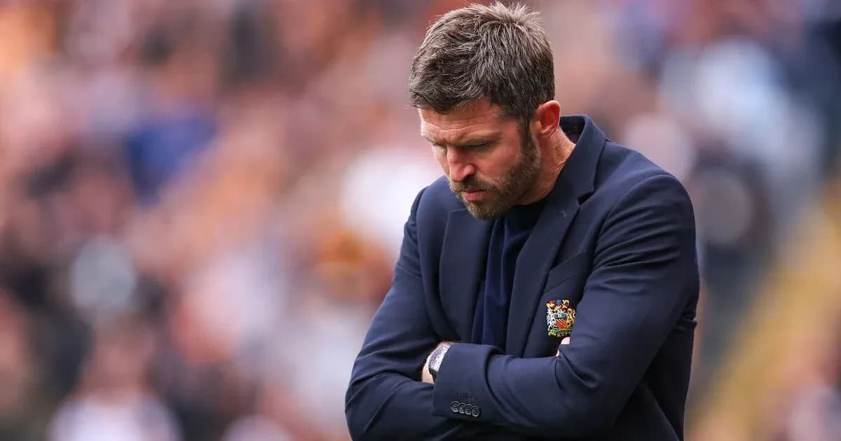 Coach with arms crossed, looking down in disappointment Coach with arms crossed, looking down in disappointment