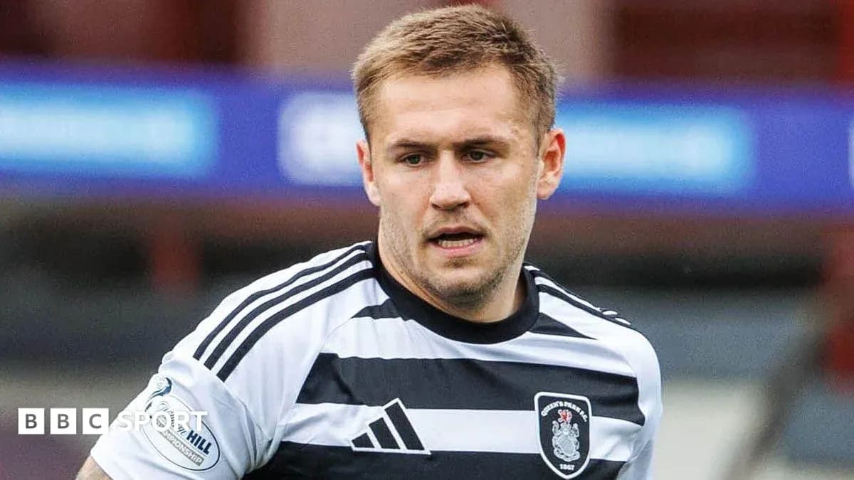 Player in black and white striped jersey on field Player in black and white striped jersey on field