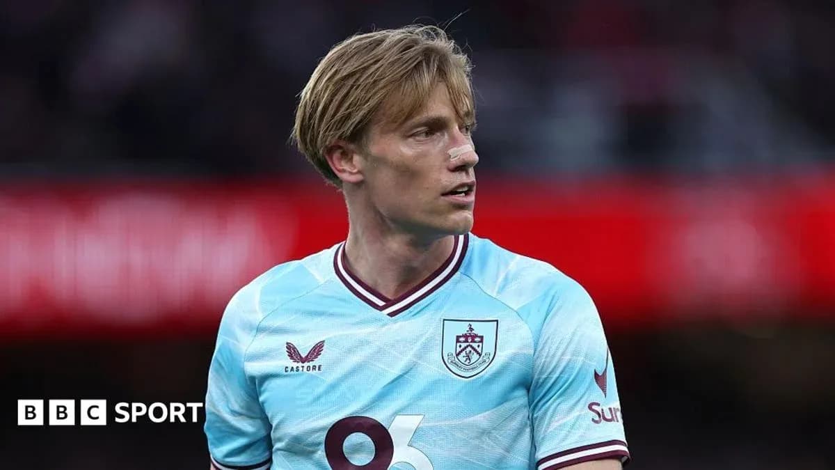 Player wearing light blue Burnley jersey on field Player wearing light blue Burnley jersey on field