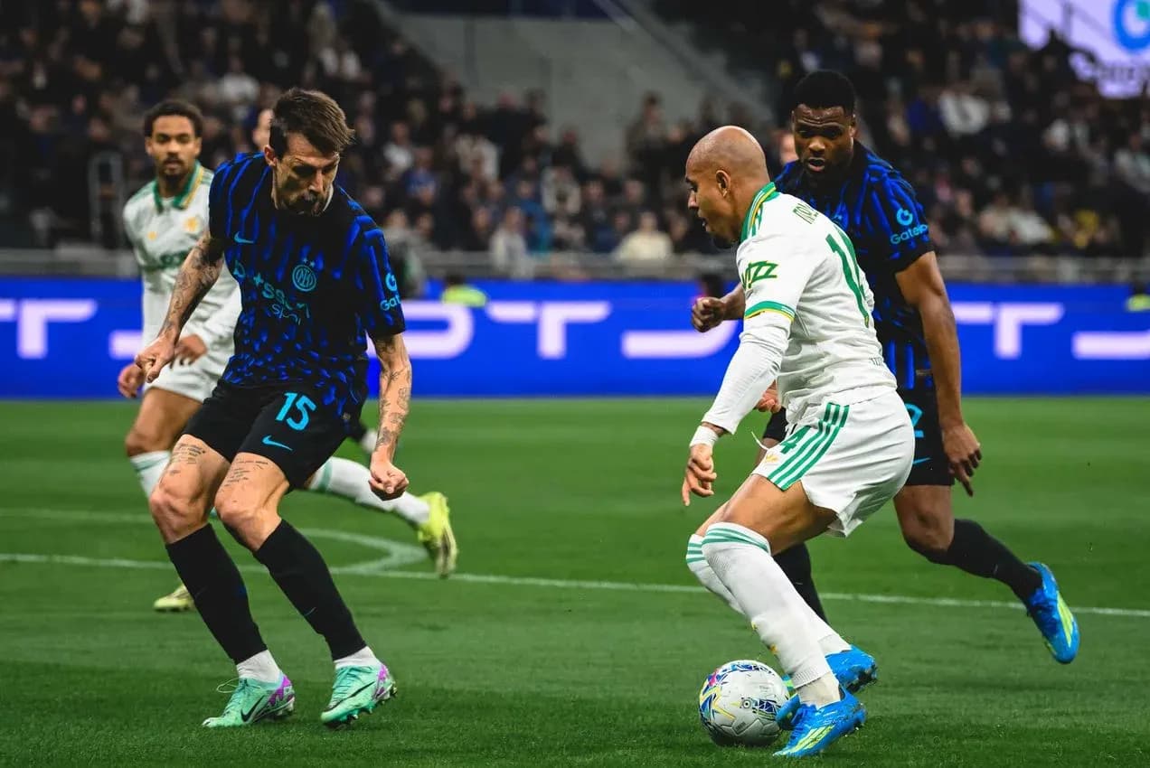Inter player challenging AS Roma opponent Inter player challenging AS Roma opponent