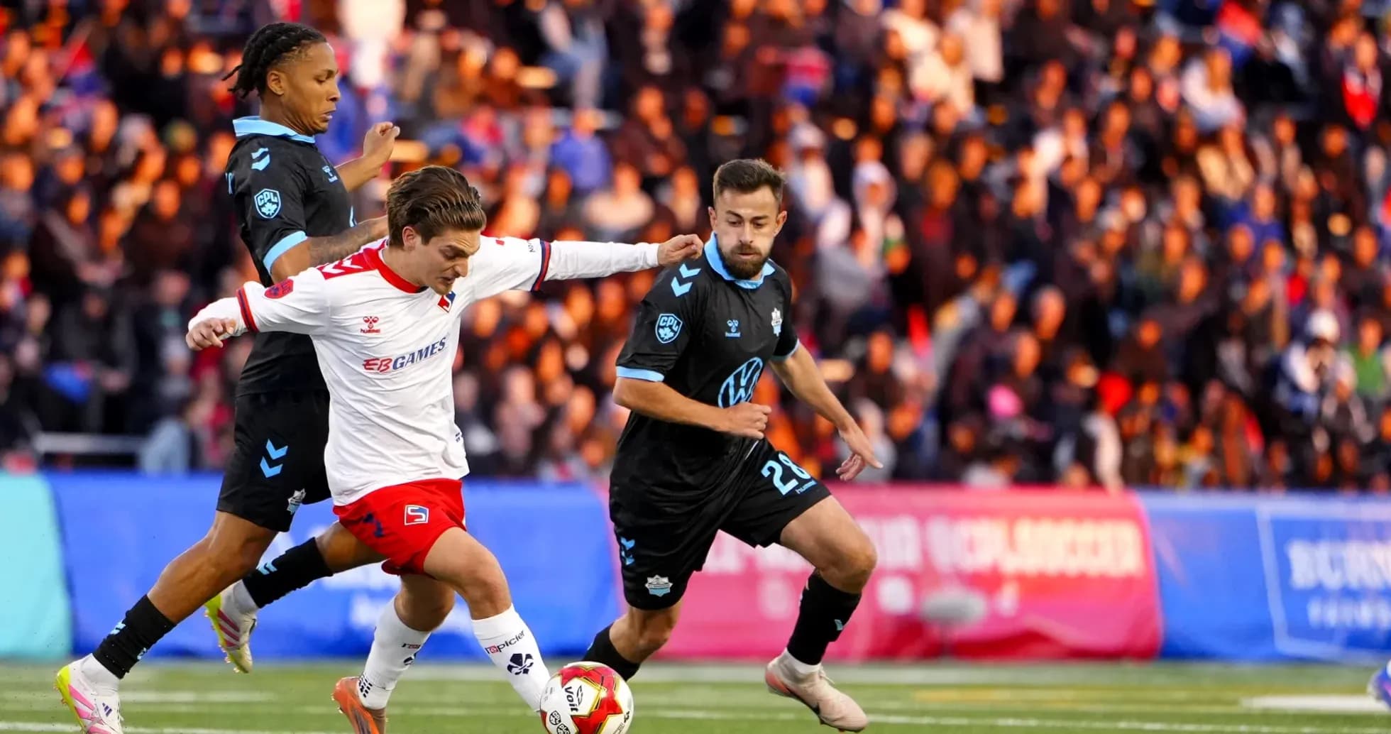HFX Wanderers FC player dribbling past opponents HFX Wanderers FC player dribbling past opponents