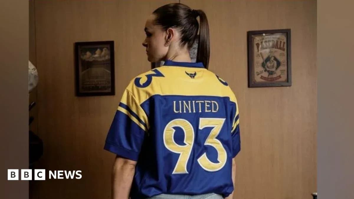Person wearing a blue and yellow jersey, back view Person wearing a blue and yellow jersey, back view