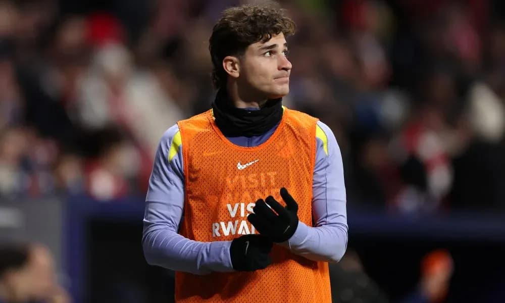 Player in warm-up vest on the sidelines Player in warm-up vest on the sidelines