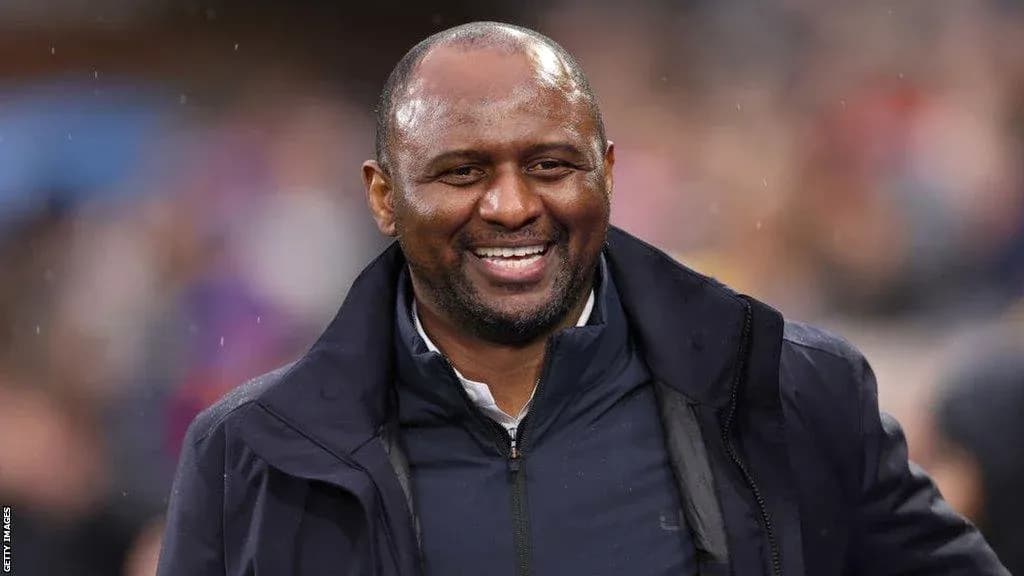 Coach smiling on the sidelines during a match Coach smiling on the sidelines during a match