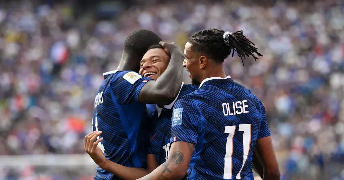 Three players celebrating a goal on the pitch Three players celebrating a goal on the pitch