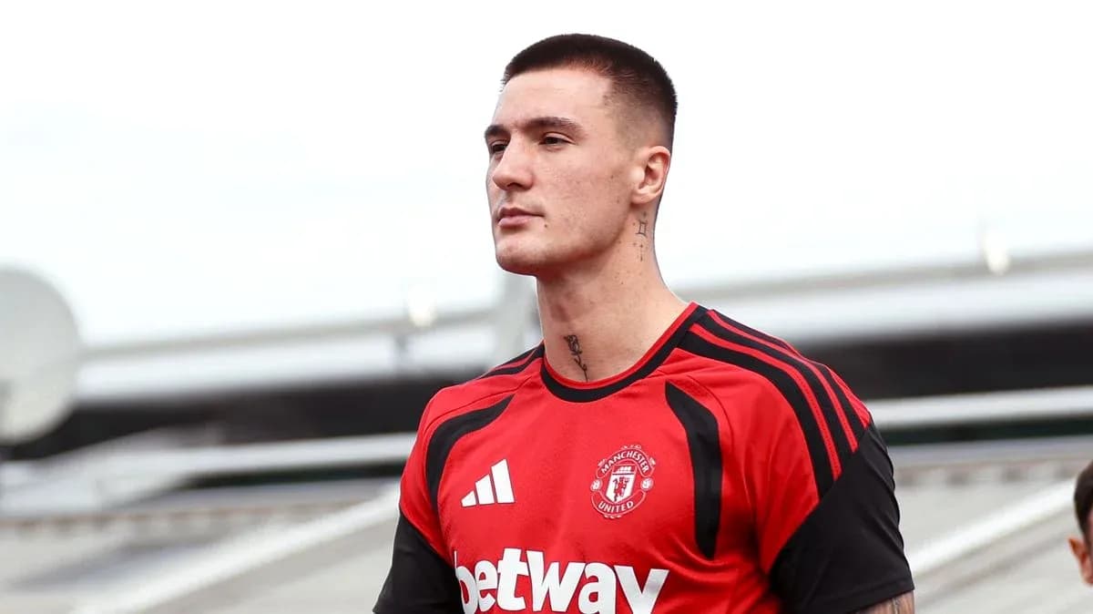 Player in Manchester United training kit on field Player in Manchester United training kit on field