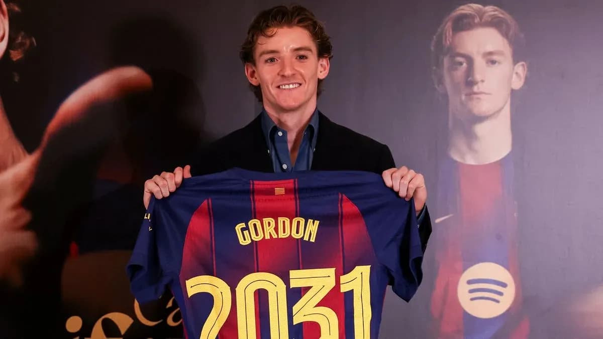 Player holding FC Barcelona jersey at presentation Player holding FC Barcelona jersey at presentation