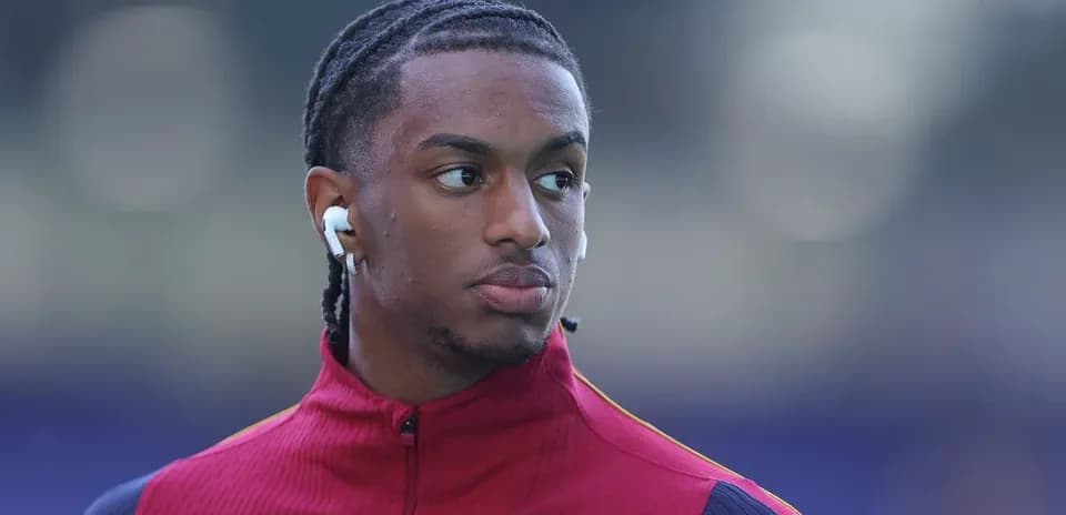 Player wearing earbuds, dressed in training gear Player wearing earbuds, dressed in training gear