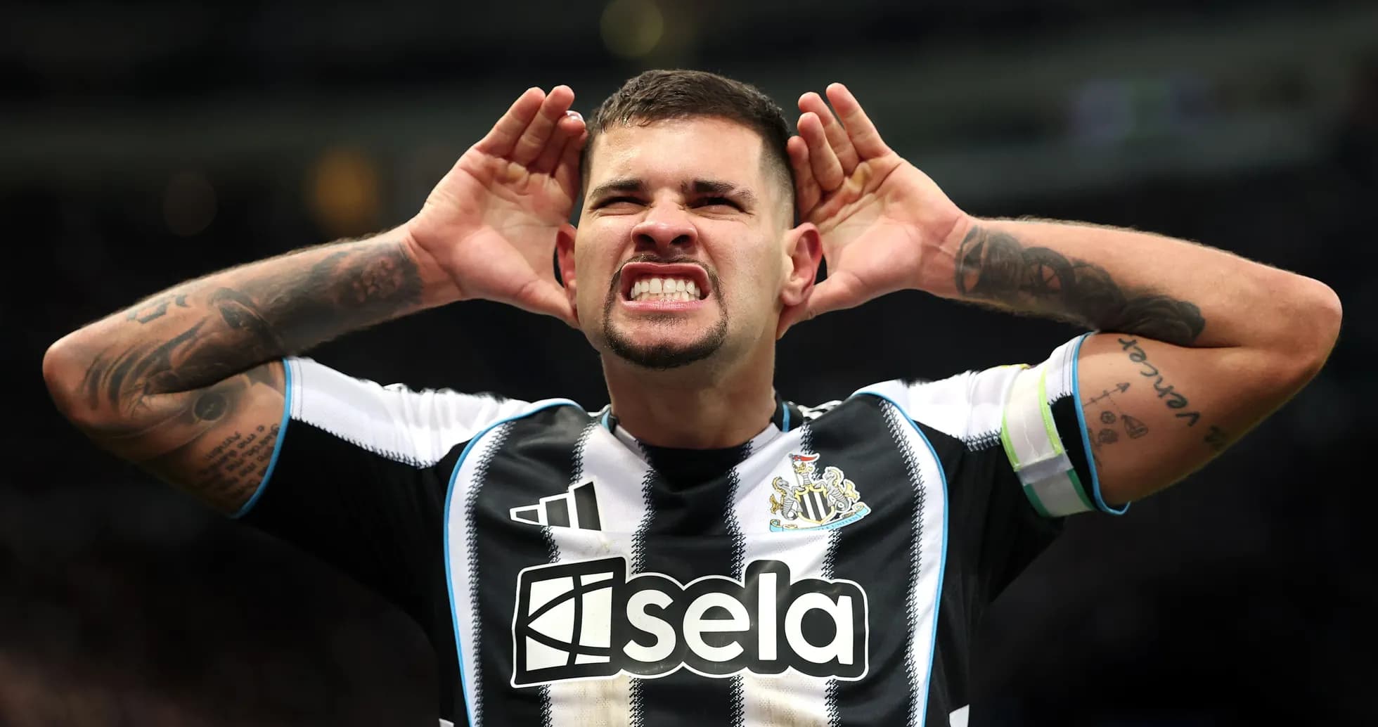 Player celebrating with hands on ears in stadium Player celebrating with hands on ears in stadium