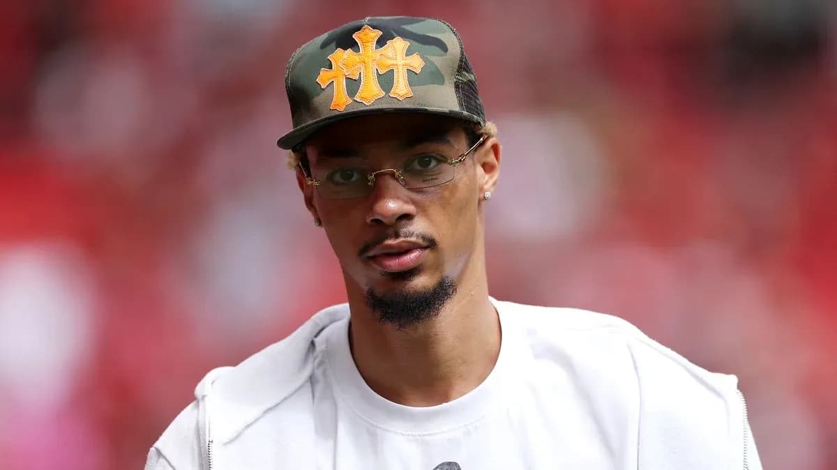 Man wearing a camo hat at sports event Man wearing a camo hat at sports event
