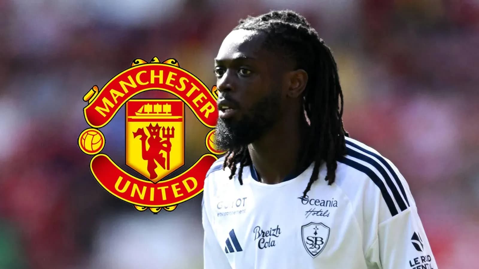 Player in white kit with Manchester United logo background Player in white kit with Manchester United logo background