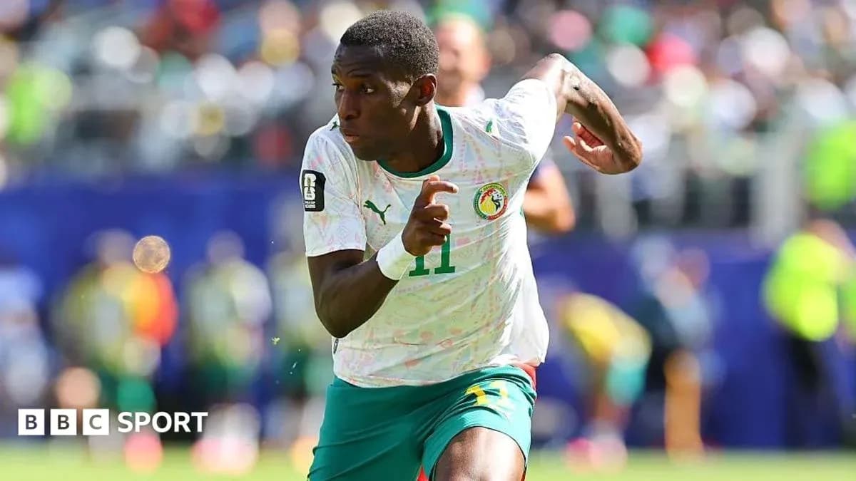 Senegal player sprinting during football match Senegal player sprinting during football match