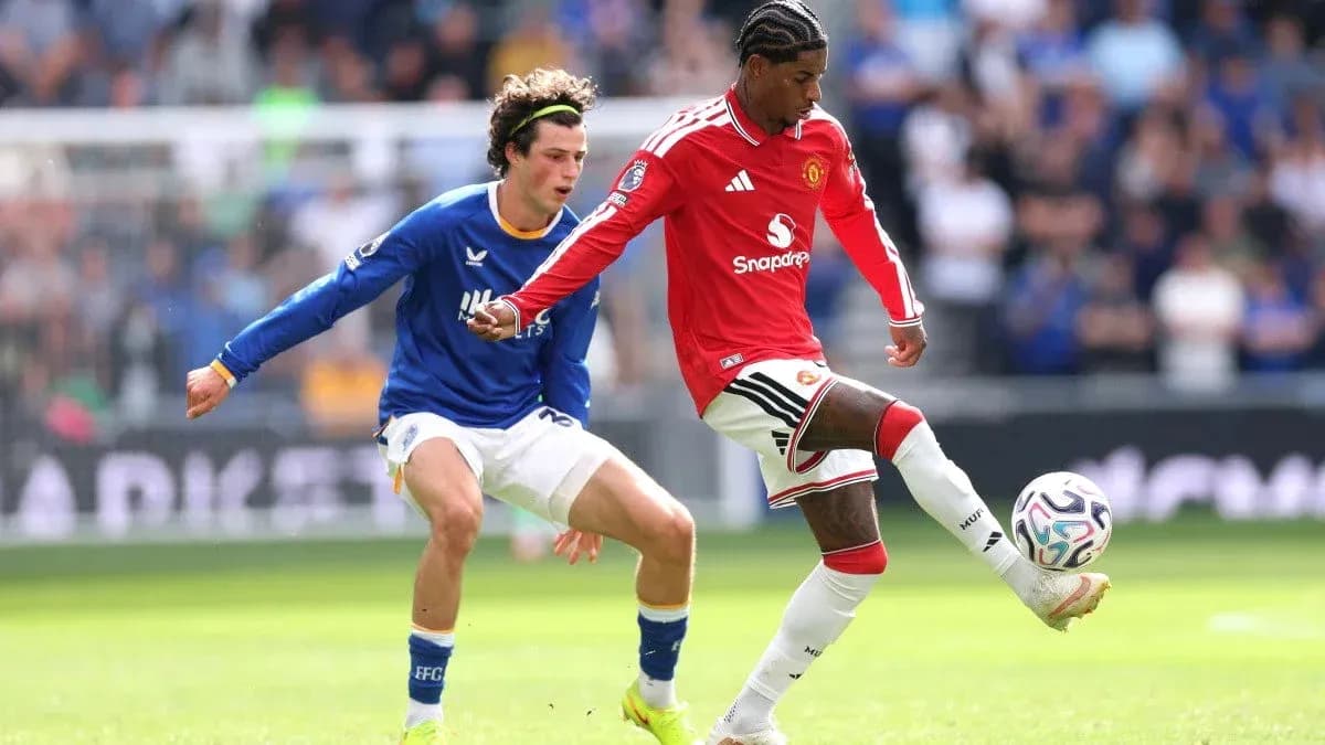 Player in red dribbling past opponent in blue Player in red dribbling past opponent in blue