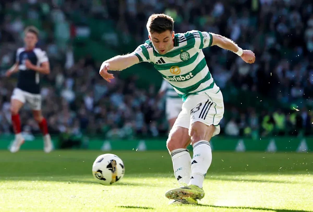 Celtic player kicking ball during match action Celtic player kicking ball during match action