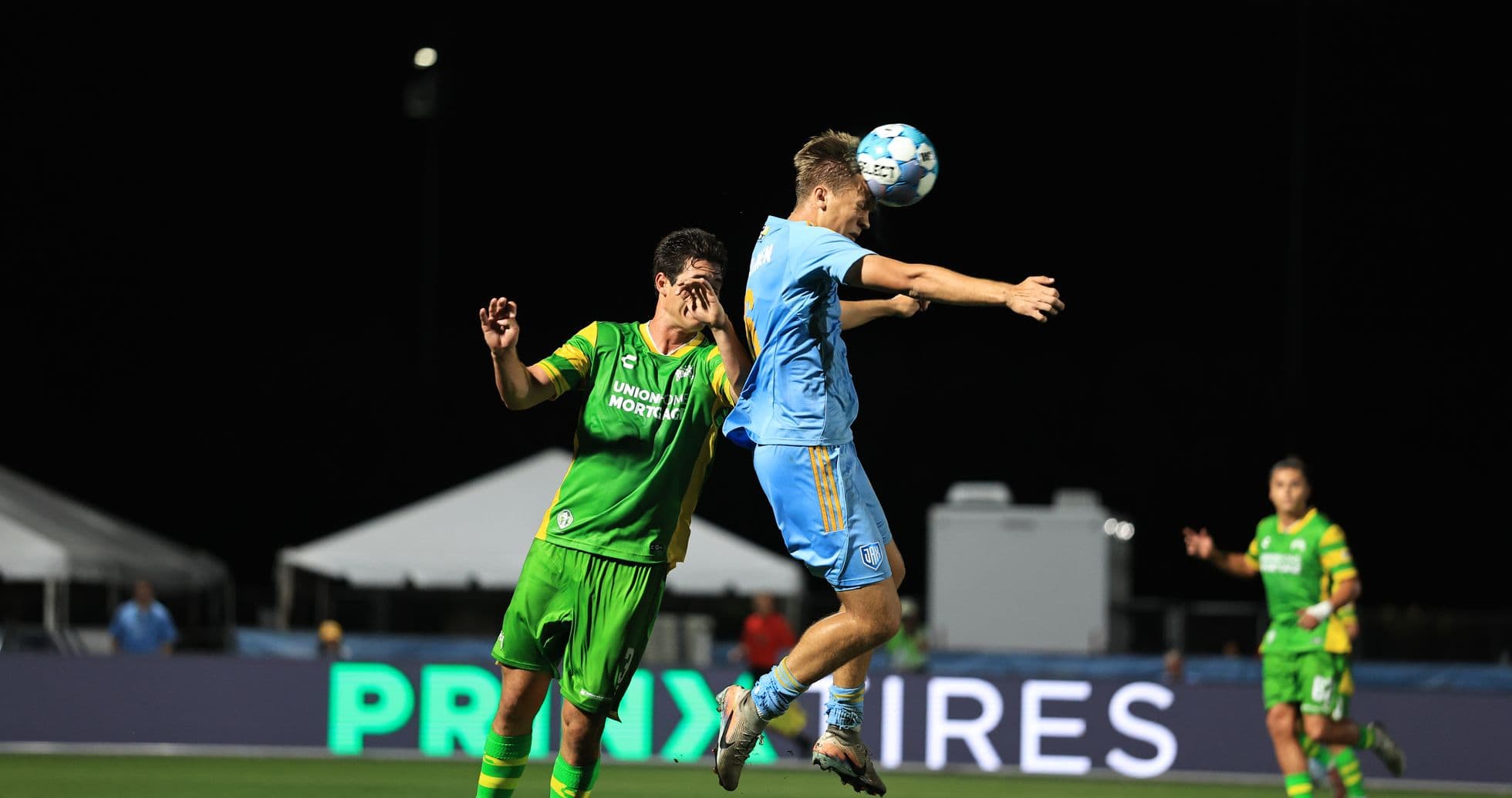 Players contesting a header during match Players contesting a header during match
