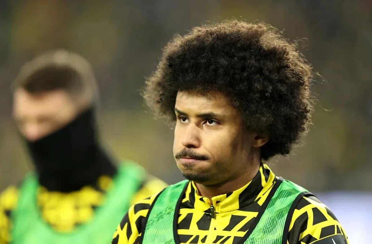 Player in team colors on the sidelines during match Player in team colors on the sidelines during match
