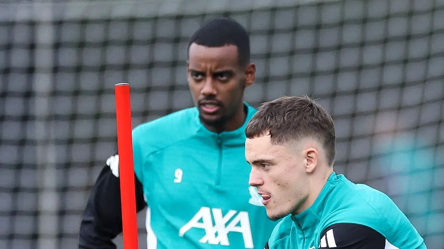 Two players training with equipment on the field Two players training with equipment on the field