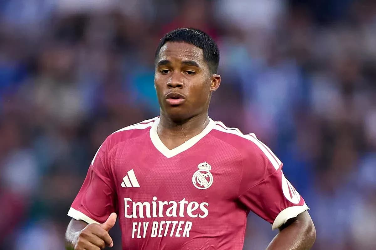 Player in pink Real Madrid jersey running on field Player in pink Real Madrid jersey running on field