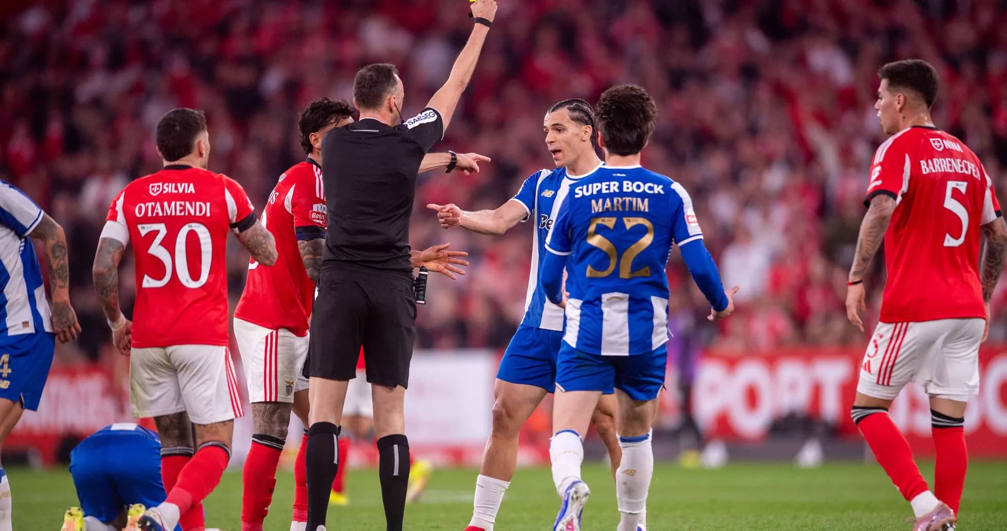 Referee showing yellow card to Porto player Referee showing yellow card to Porto player