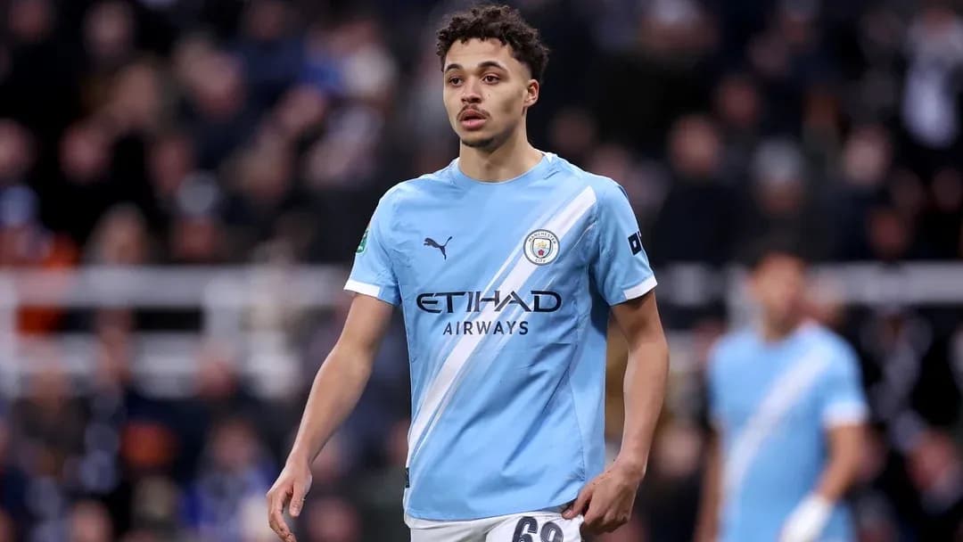Player in light blue Manchester City kit on field Player in light blue Manchester City kit on field