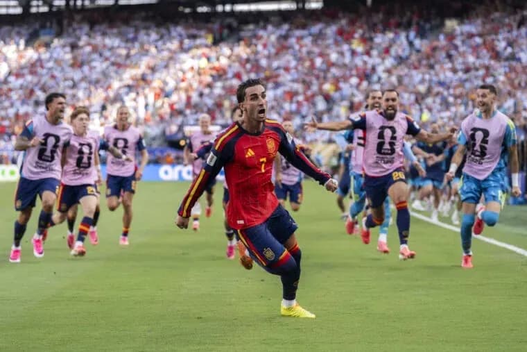Spanish player celebrating a goal with teammates Spanish player celebrating a goal with teammates