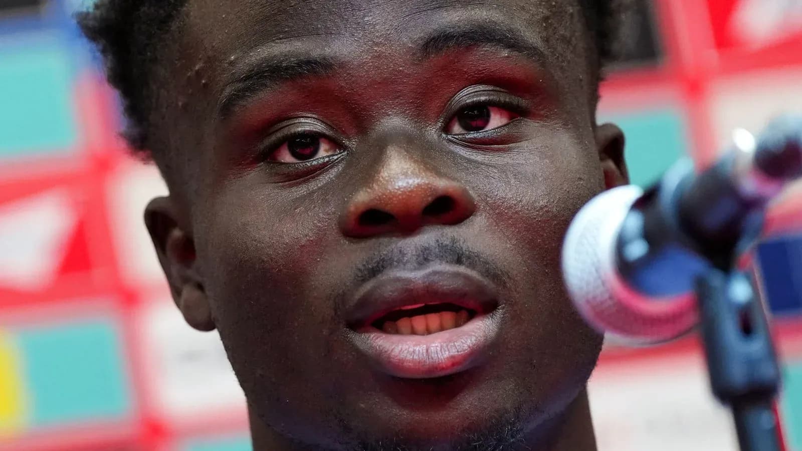 Player speaking at a press conference microphone Player speaking at a press conference microphone