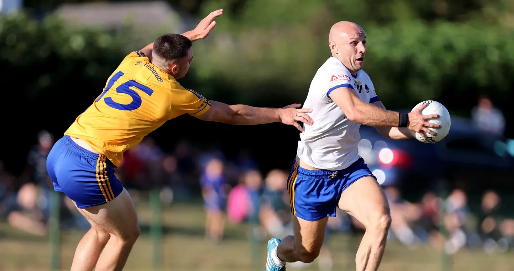 Player running with the ball while being tackled Player running with the ball while being tackled