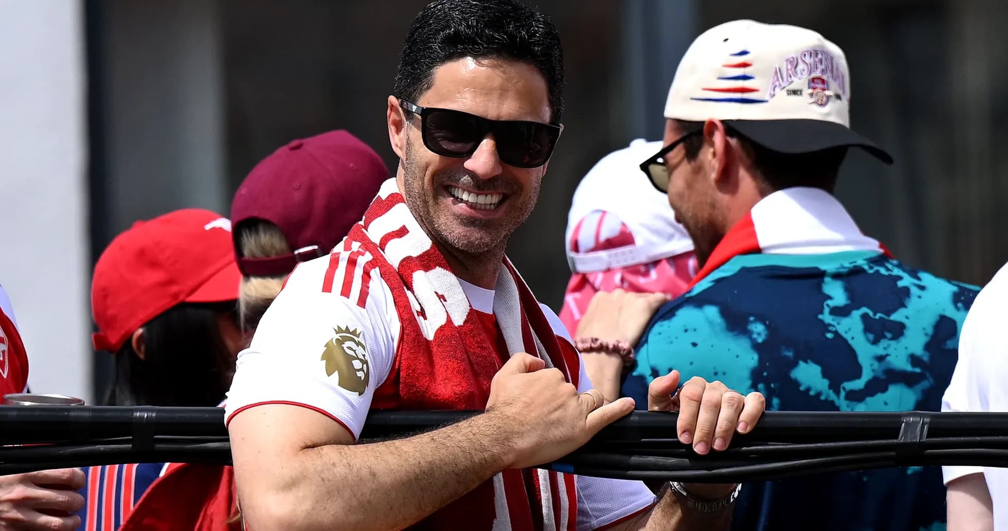 Man in sunglasses celebrating with fans at event Man in sunglasses celebrating with fans at event