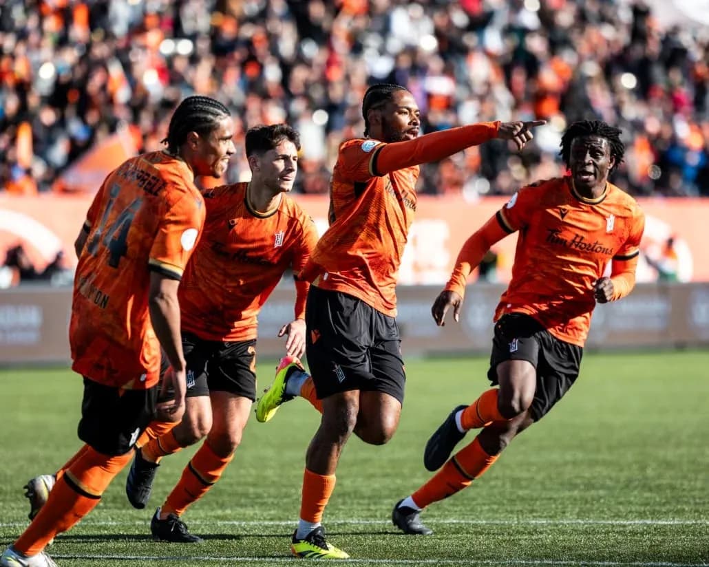 Players celebrating a goal during match Players celebrating a goal during match