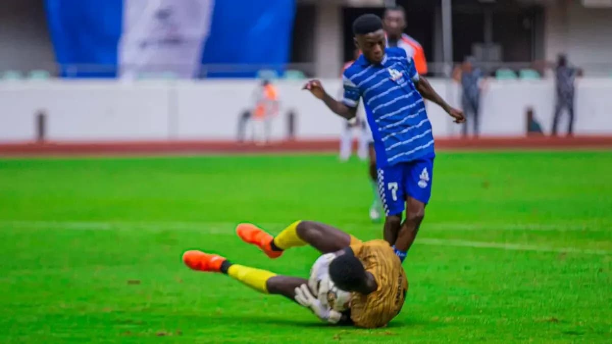 Player tackling goalkeeper during NPFL match Player tackling goalkeeper during NPFL match