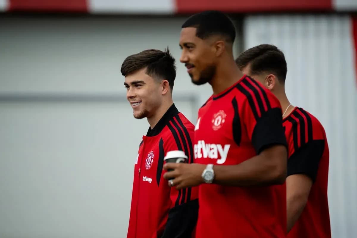 Two Manchester United players in training gear smiling Two Manchester United players in training gear smiling