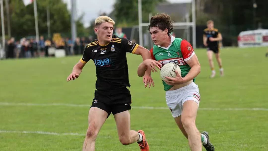 Two players competing for a Gaelic football Two players competing for a Gaelic football
