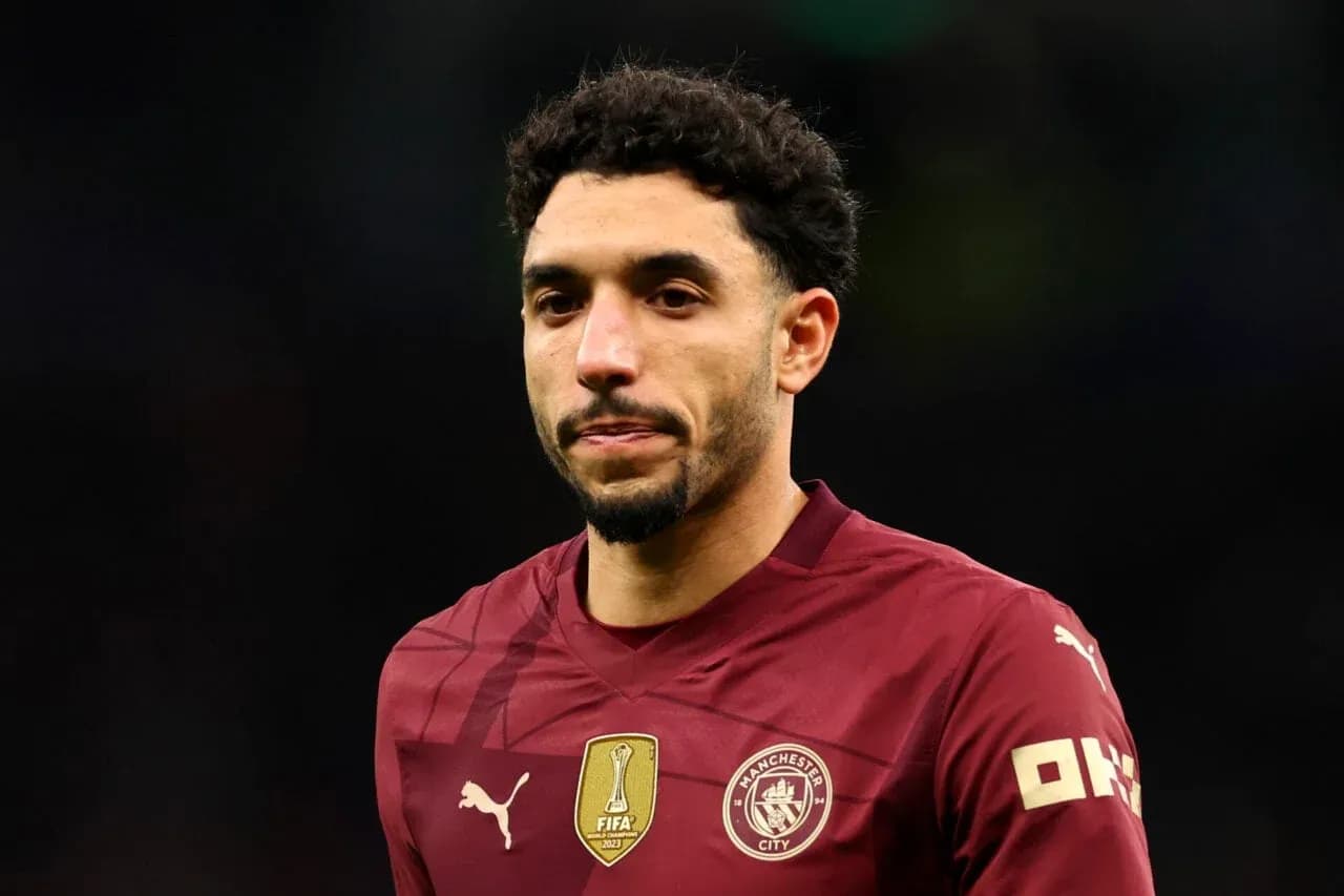 Player wearing Manchester City jersey on the field Player wearing Manchester City jersey on the field