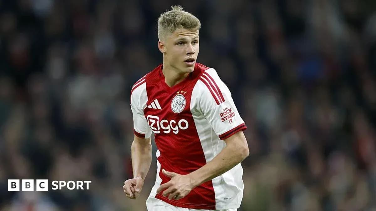 Player in Ajax jersey running during match Player in Ajax jersey running during match