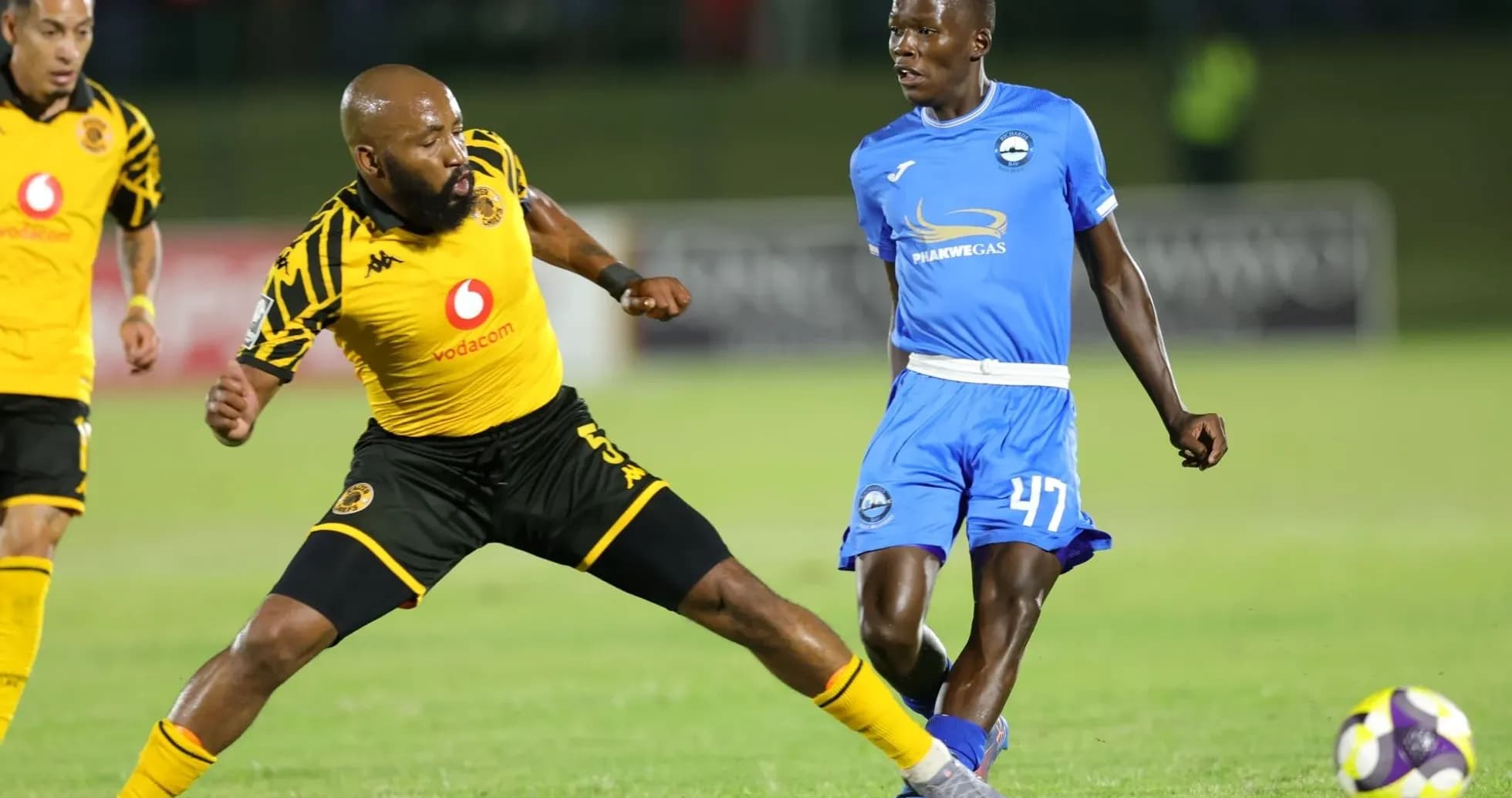 Two players competing for the ball on the field Two players competing for the ball on the field