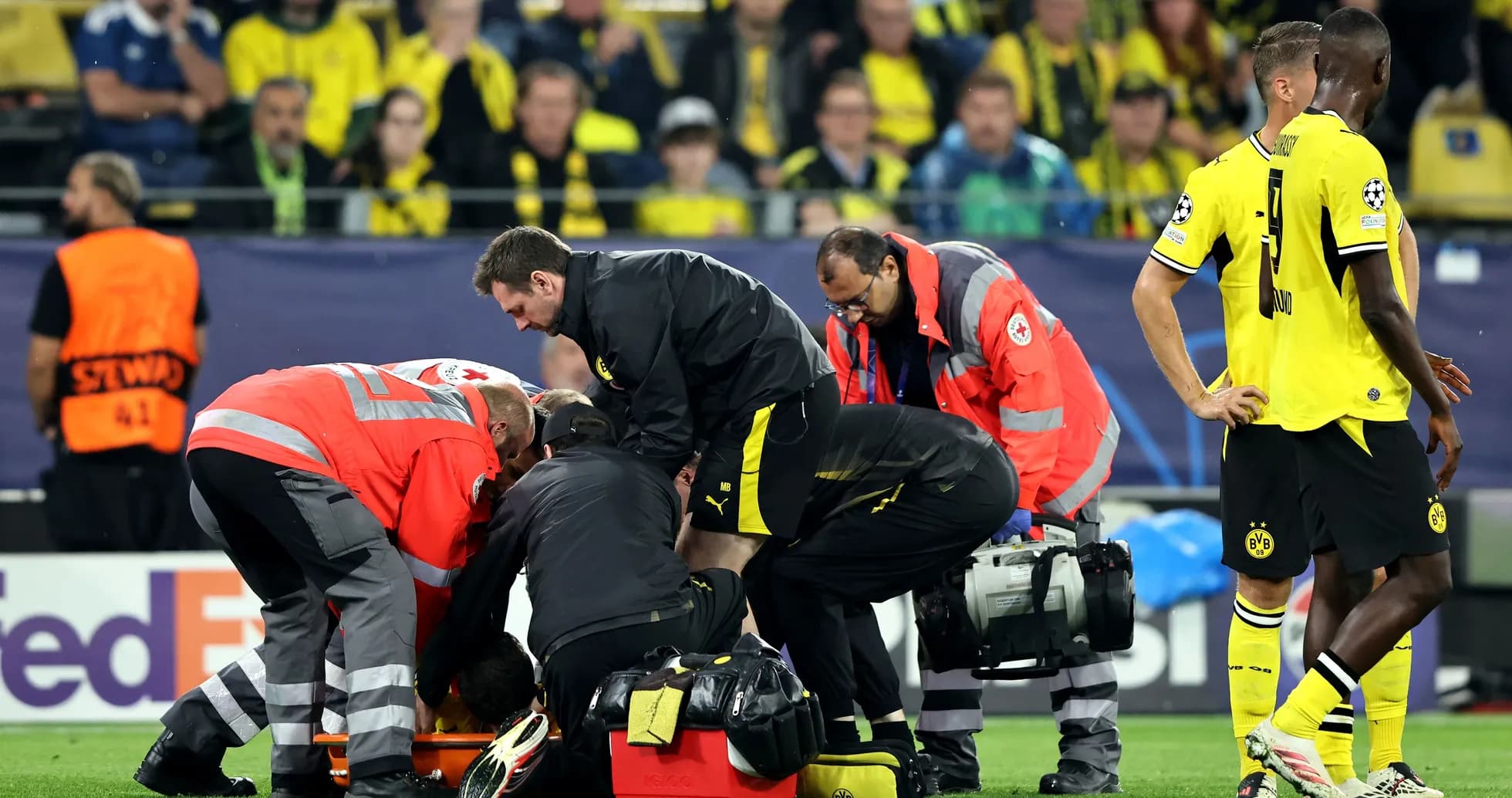 Medical staff attending to a player on the ground Medical staff attending to a player on the ground