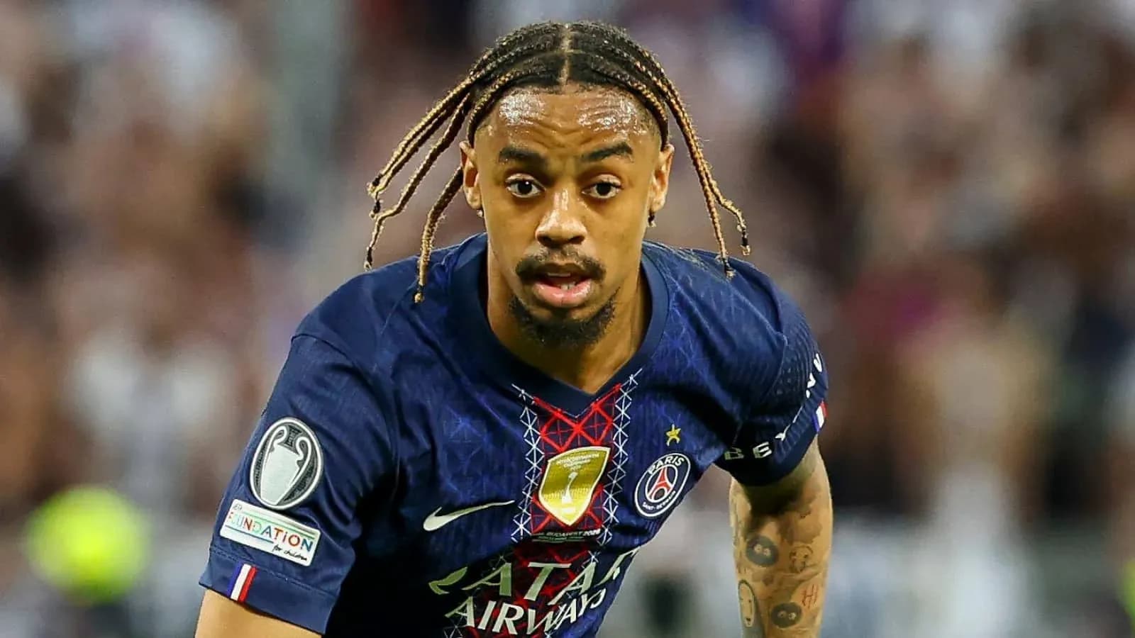 Player in PSG kit running during a match Player in PSG kit running during a match