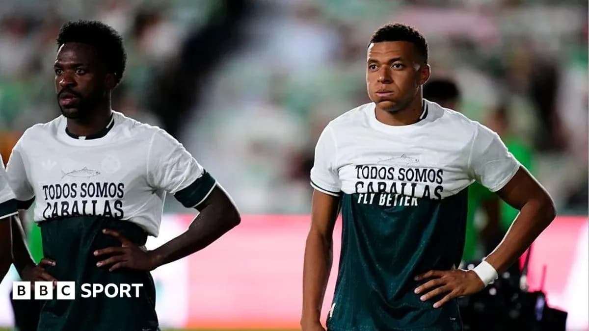 Two players wearing warm-up shirts on pitch Two players wearing warm-up shirts on pitch